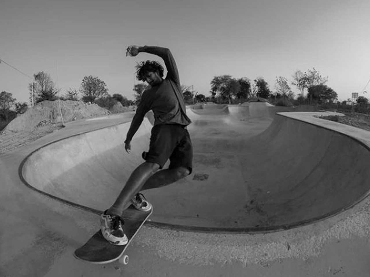 Photo of a skater doing a trick in a skatepark